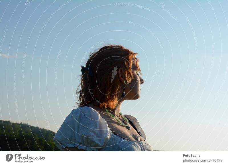 Young woman enjoys the sun sunny Sympathetic stands dress sweet Charming young summer Caucasian outside Pretty Human summer time copy space teenager sunbathing