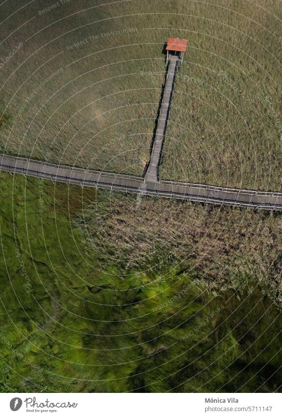 aerial view. Wooden walkway in the Ulla River wetland in Torres do Oeste, Catoira wood path nature green grass stroll river galicia Pontevedra landscape travel