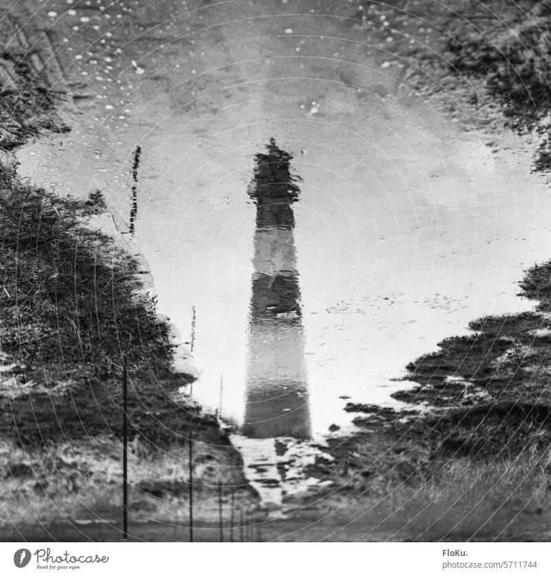 Westerheversand lighthouse reflected in a puddle Lighthouse Western Europe North Sea coast Landscape Vacation & Travel Deserted Nature Sky Ocean Exterior shot