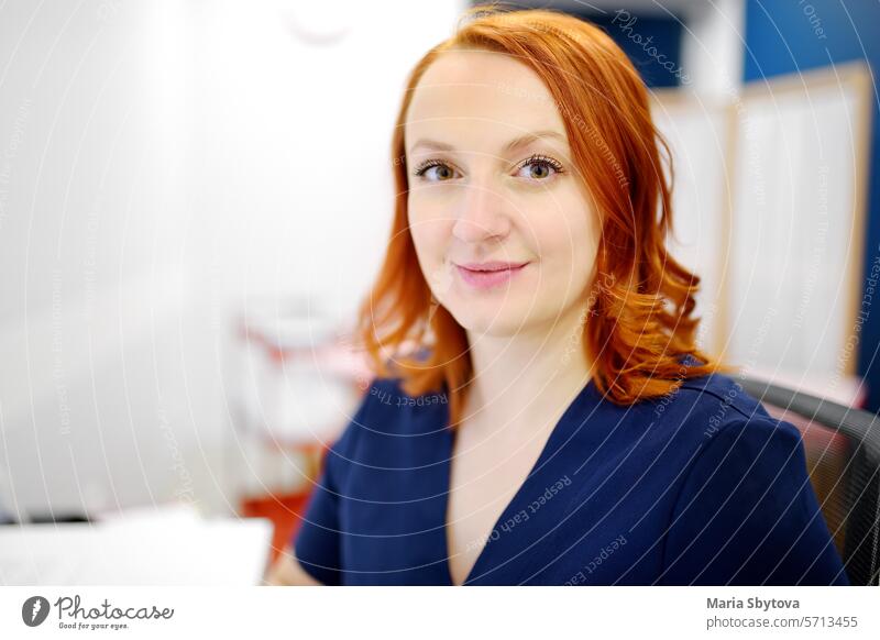 Portrait of a smiling female neurologist looking at camera in the office of a modern clinic. The neurology doctor is at work. portrait woman medical