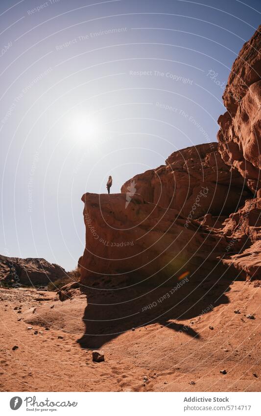 Adventurer atop a rock formation in Purmamarca desert adventurer purmamarca tourist argentina sandstone sun bright northern argentina exploration person travel