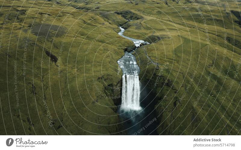 Majestic Waterfall in the Green Landscape of Iceland iceland waterfall landscape nature natural beauty green hills serene cascade pool verdant scenic isolated