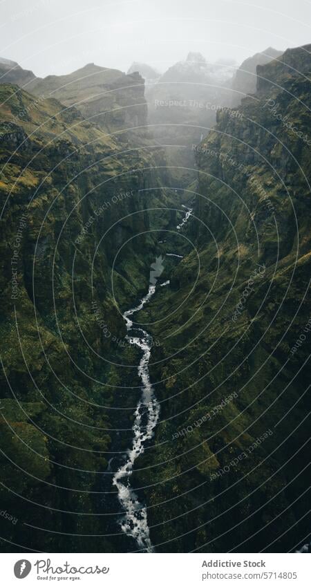 Aerial view of a misty waterfall in Iceland iceland landscape aerial rugged cascade nature travel tourism adventure scenic beauty outdoors greenery valley river