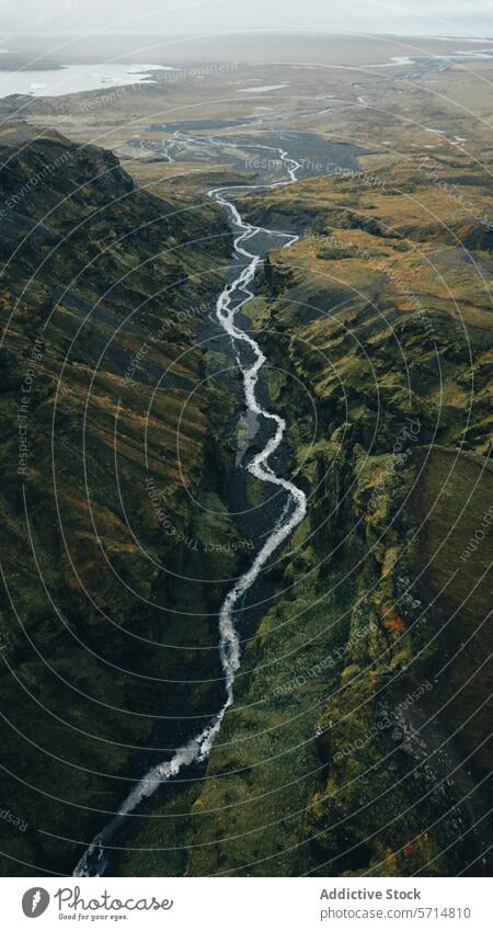 Aerial view of a misty waterfall in Iceland iceland landscape aerial rugged cascade nature travel tourism adventure scenic beauty outdoors greenery valley river