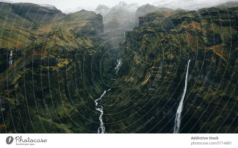 Aerial view of a misty waterfall in Iceland iceland landscape aerial rugged cascade nature travel tourism adventure scenic beauty outdoors greenery valley river