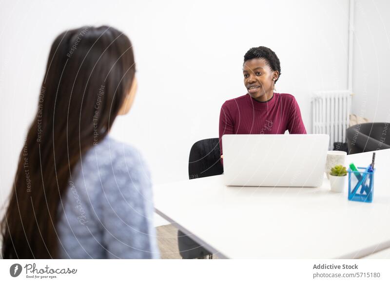 Colleagues discussing work in a modern office discussion professional laptop colleague conversation bright business meeting technology corporate teamwork