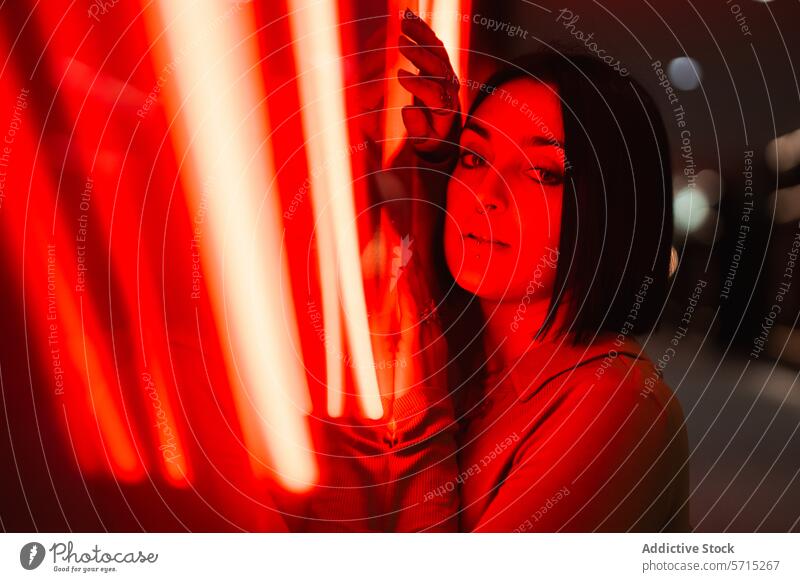 Urban style portrait of woman in red neon light urban glow night moody expressive young fashion city life modern female expression ambient trendy hip vibe