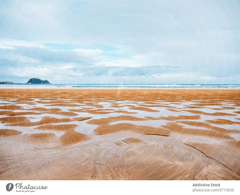 Tranquil beach with gentle waves and textured sands ripple sea ocean cloudy sky tranquil serene springtime landscape nature seascape water coastline shore tidal