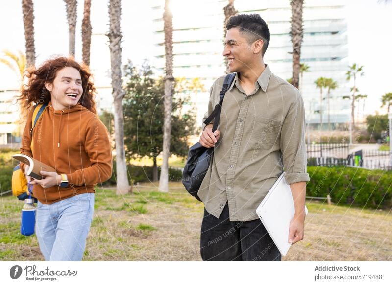 Multicultural students laughing during an outdoor break college university picnic conversation diverse multicultural multiethnic friendship communication man