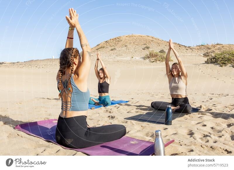 Beach yoga session at sunset in Sukhasana pose beach sukhasana practice serenity enthusiast stretching tranquility fitness wellbeing meditation health exercise