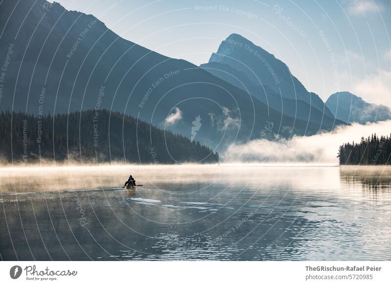 Canoeists on the lake - morning mist still hangs over the lake Lake Man Highway ramp (exit) Fog Moody morning light Landscape Nature Dawn Calm morning mood