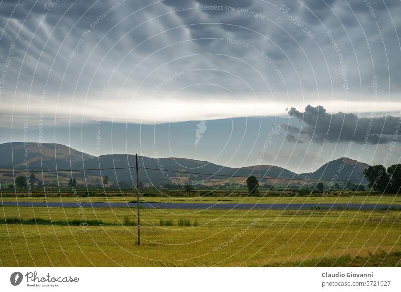 Rural landscape near Colfiorito, Marche, Italy, at summer Europe Macerata color country day farm field green hill nature photography plant rural storm travel