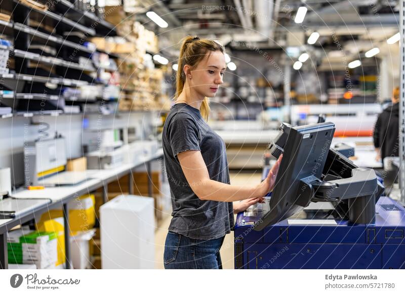 Woman working in a printing factory business employee female industrial industry job logistics manufacture manufacturing occupation people product production