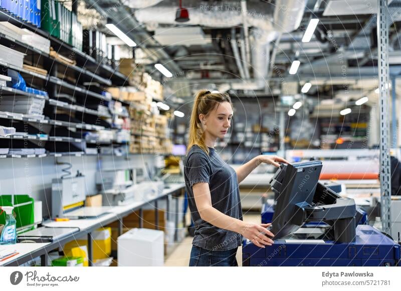 Woman working in a printing factory business employee female industrial industry job logistics manufacture manufacturing occupation people product production