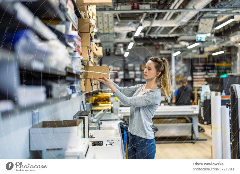 Woman working in a printing factory business employee female industrial industry job logistics manufacture manufacturing occupation people product production