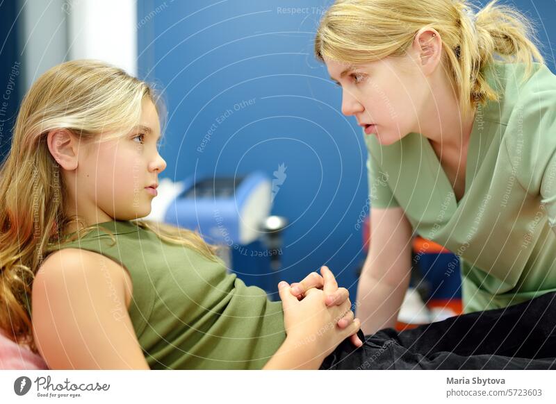 Schoolgirl patient is at pediatrician appointment and feeling unwell. Caring female doctor asking young girl about state of health. Treatment of viral and infectious diseases.