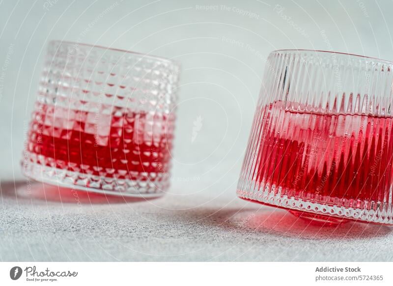 Cherry vodka and tonic cocktail in textured glasses cherry ice beverage drink alcohol refreshment mixology bar vibrant simplicity backdrop serving ice cube