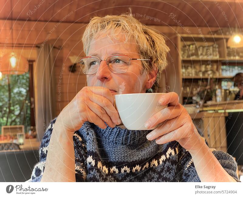 Woman drinking coffee looks dreamily out of the window portrait Young woman Hair and hairstyles Adults Face Looking Face of a woman naturally