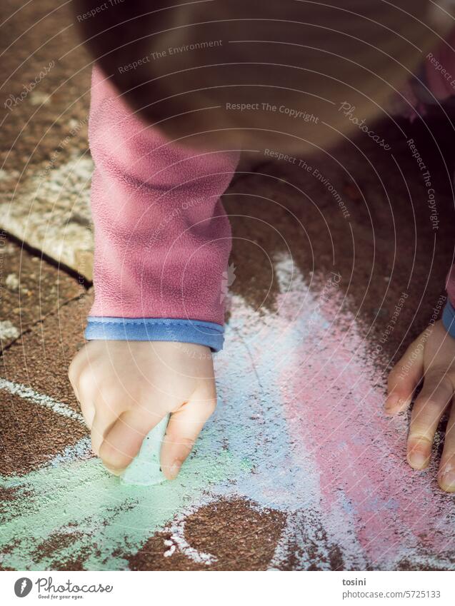 Girl colors the floor with chalk Chalk Street painting Exterior shot Colour photo Infancy Painting (action, artwork) Multicoloured Art Joy Playing Creativity