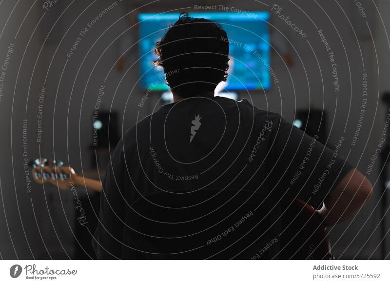 Anonymous male musician with Guitar Preparing for Recording Session guitar studio session recording sound monitor computer screen background equipment audio