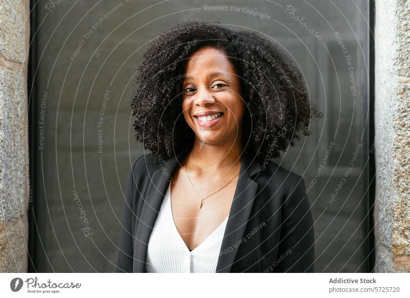 Confident businesswoman smiling outdoors in city female african american professional smile confidence office building business attire cheerful pose corporate