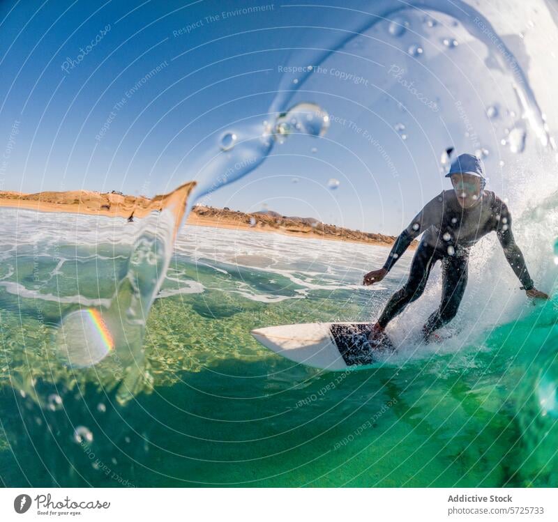 Action-packed image of a focused surfer in a wetsuit carving through a cresting wave, with water droplets suspended around ride ocean sea action sport dynamic