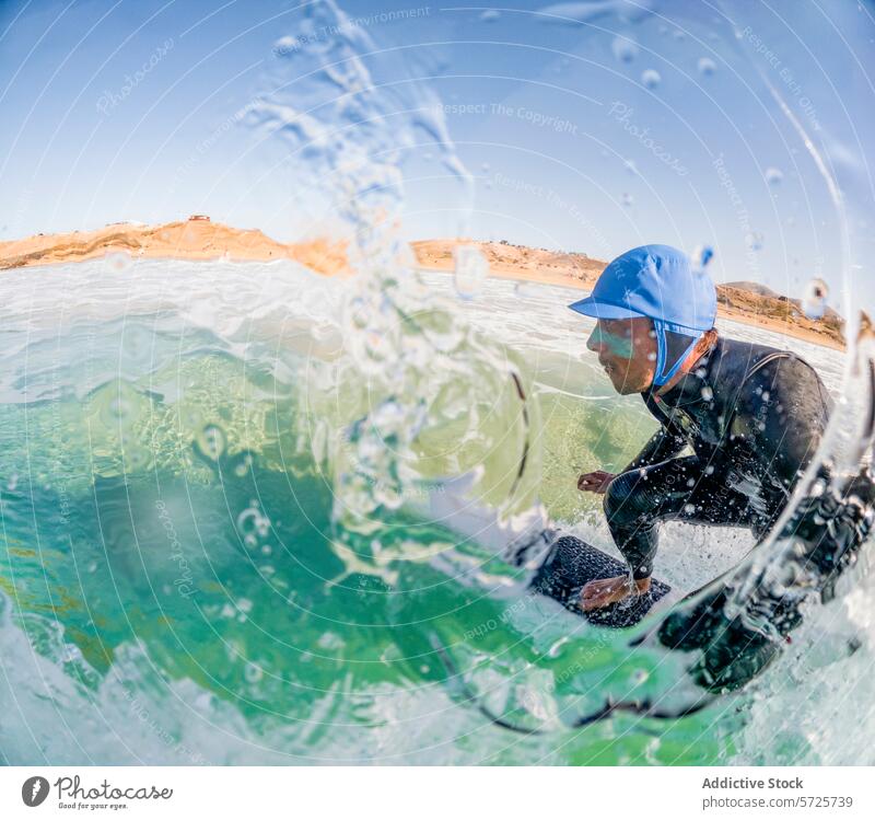 Dynamic shot of a surfer in a wetsuit riding a green wave, seen through a curtain of sparkling water droplets, under a blue sky ride ocean sea texture sport