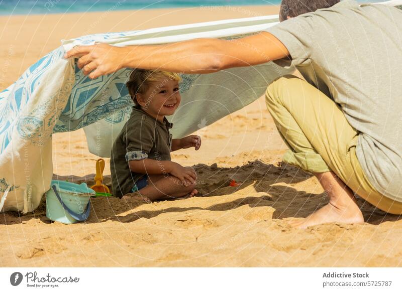 Joyful Beach Moments with Family beach toddler family fun sand play smile happiness tent summer joy togetherness leisure vacation coast seaside outdoor playful