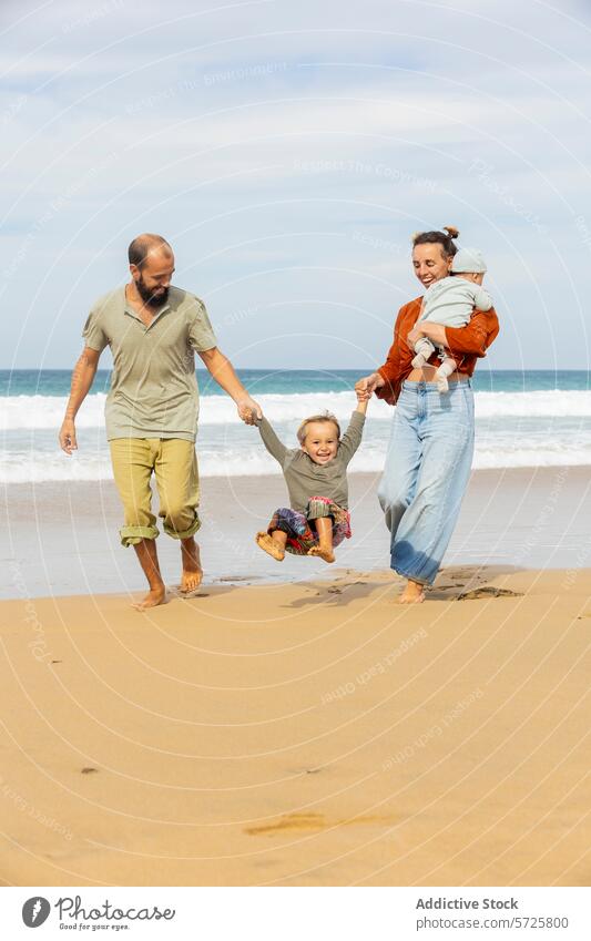 Joyful family moments on a sandy beach fun walk parents child toddler swing carry joyful playful ocean leisure vacation happiness bonding togetherness outdoors