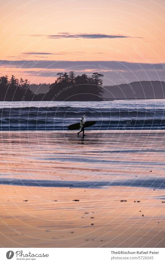 Surfers walking along the beach in the evening mood cox bay Vancouver Island Ocean White crest Waves Canada British Columbia North America Water coast Nature