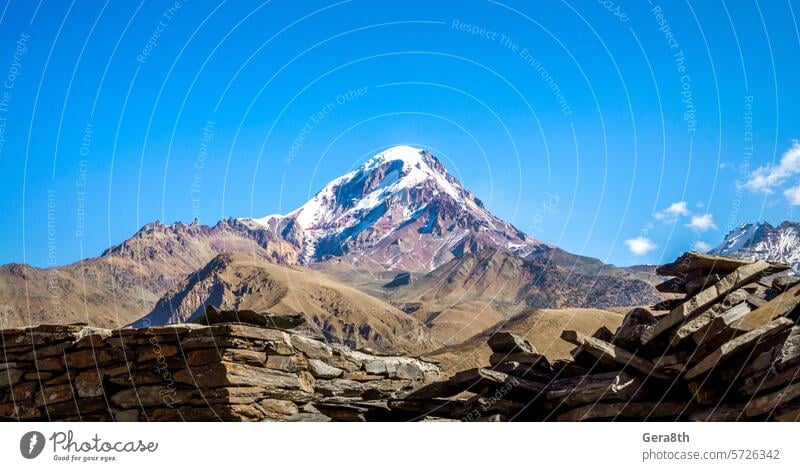 high rocky mountains of the Caucasus in Georgia Georgia country autumn background blue climate clouds day grass heat ice landscape natural nature peak plant