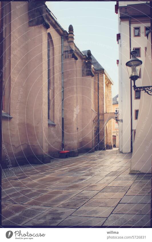 Alley in the old town with Gothic archway Old town Church walls Archway gothic architecture Building streetlamp Gas lamp Historic Manmade structures Bretgasse