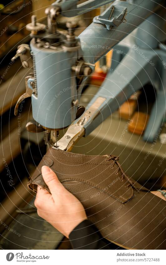 Artisan shoemaker at work in Austrian workshop austria craftsmanship hands sewing machine leather artisan close-up traditional stitch tool skill manual brown