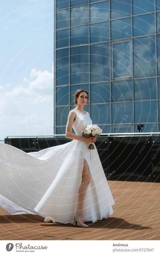 bride the roof of skyscraper blue bouquet city day dress first forever groom happiness joy meeting newlyweds smiles suit summer together top two walking wedding