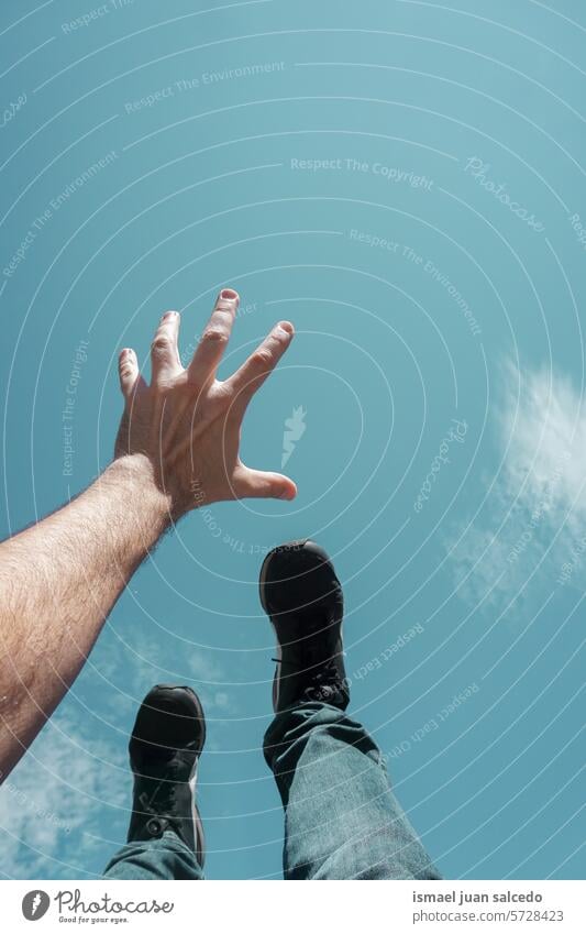 feet and hand gesturing in the blue sky, happiness arm fingers hand up arm up hand raised arm raised skin palm palm of hand body part sun sunlight rainbow flash