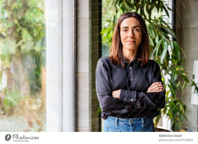 Confident Businesswoman Standing in an Office Environment businesswoman office professional confident standing leadership expertise indoor plants well-lit