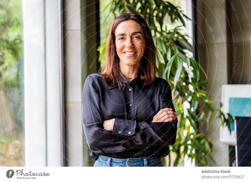 Confident businesswoman at modern office professional smile environment confidence indoor corporate casual standing looking at camera female entrepreneur