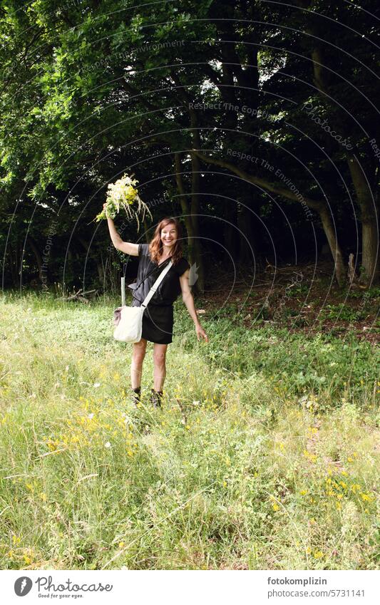 Woman on meadow with bouquet of flowers Meadow meadow flowers Bouquet Wave cheerful Laughter wild flowers flower girl wild meadow outdoor Nature Summer Spring