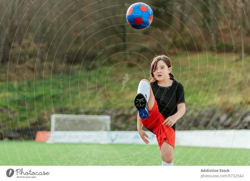 Young soccer player kicking ball on field girl young sport determination youth grassy outdoor activity football athletic child energetic training practice