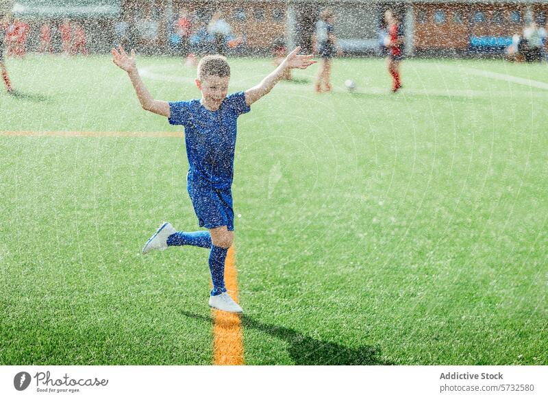 Joyful Child Playing Soccer in the Rain child soccer rain play joy happiness sports outdoor boy youthful enjoyment active field green grass sportswear