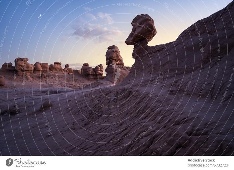 Twilight hues over hoodoos in Goblin Valley, Utah goblin valley utah usa twilight rock formation crescent moon silhouetted enchanting landscape dusk sandstone