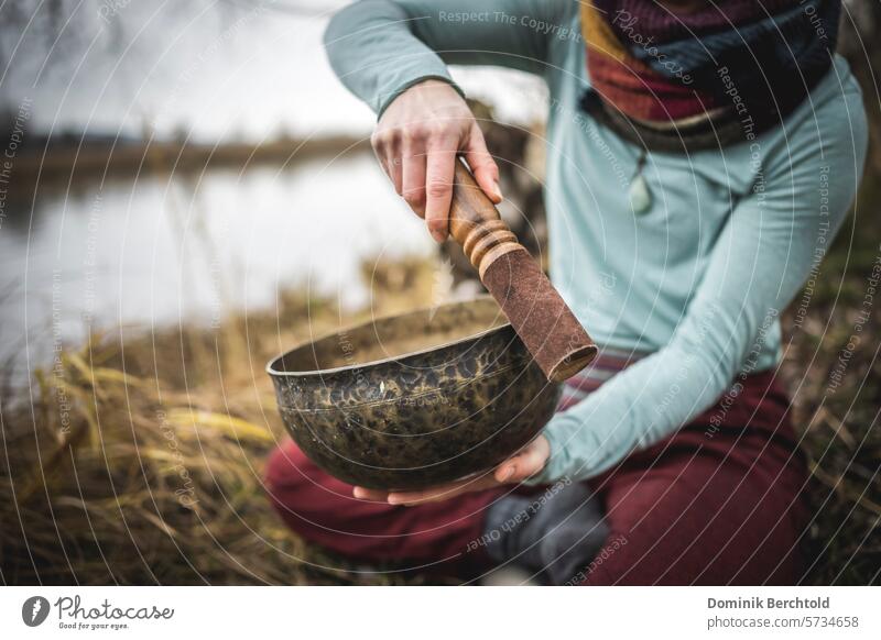 Meditation at the lake singing bowl Singing bowls Yoga yoga exercise Healthy Relaxation Bowl Sound Colour photo Calm Woman Well-being Harmonious Contentment