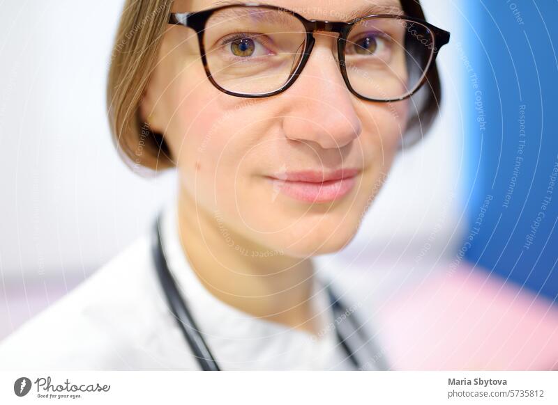 Close up portrait of young female doctor cardiologist during appointment of patient. Cardiology consultation and treatment of heart diseases woman intern