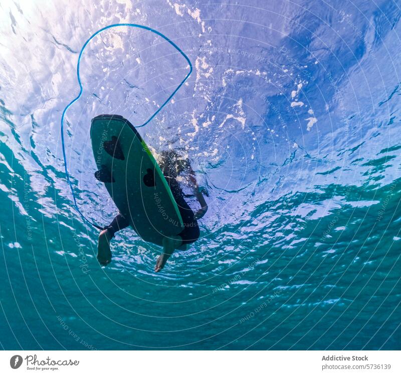 Underwater View of Surfer in Fuerteventura underwater surfer duck dive clear wave fuerteventura marine landscape ocean sport surfing aqua blue sea adventure