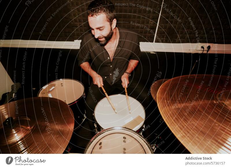 Male drummer in action at a music performance male drum set black attire playing passion instrument cymbal snare hi-hat tom-tom bass drum stick beat rhythm