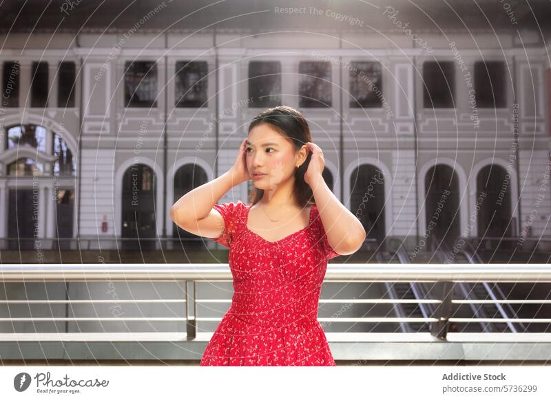 Young woman in red dress posing in urban setting asian fashion style young adult female pose confident elegance casual summer outdoor building historic