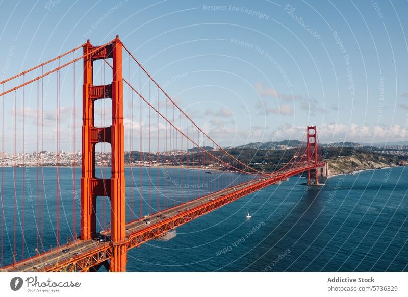 A clear spring day offers a breathtaking view of the Golden Gate Bridge with the San Francisco skyline and sailing boats dotting the bay sailboat