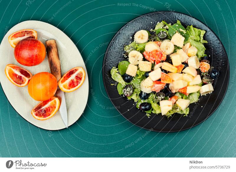 Oranges fruit salad orange banana grapes food diet green healthy fresh vegetarian flat lay top view vitamin delicious plate vegan citrus raw leaf nutrition mix