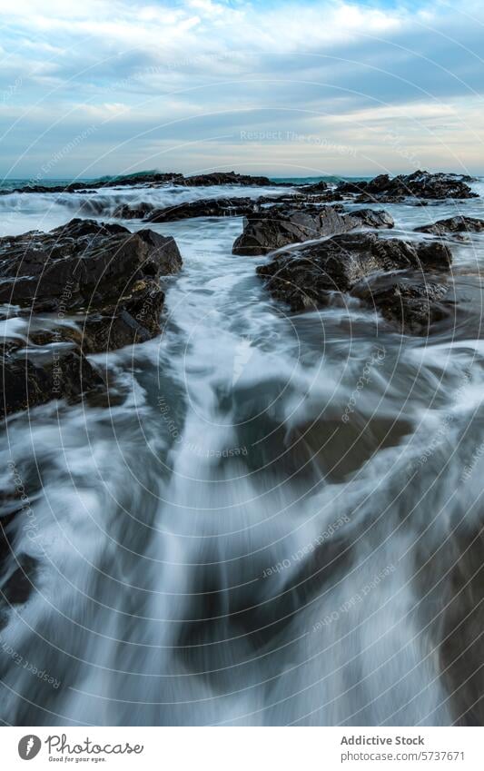 Serene beach scene with rocky shores in Mijas, Spain coast mijas spain wave long-exposure serene seascape nature landscape water ocean motion tranquil travel