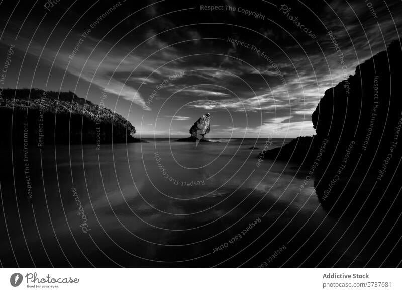 Serene monochrome seascape of Playa Buelna, Spain playa buelna llanes asturias spain black and white tranquil dusk dramatic clouds rock formation serene